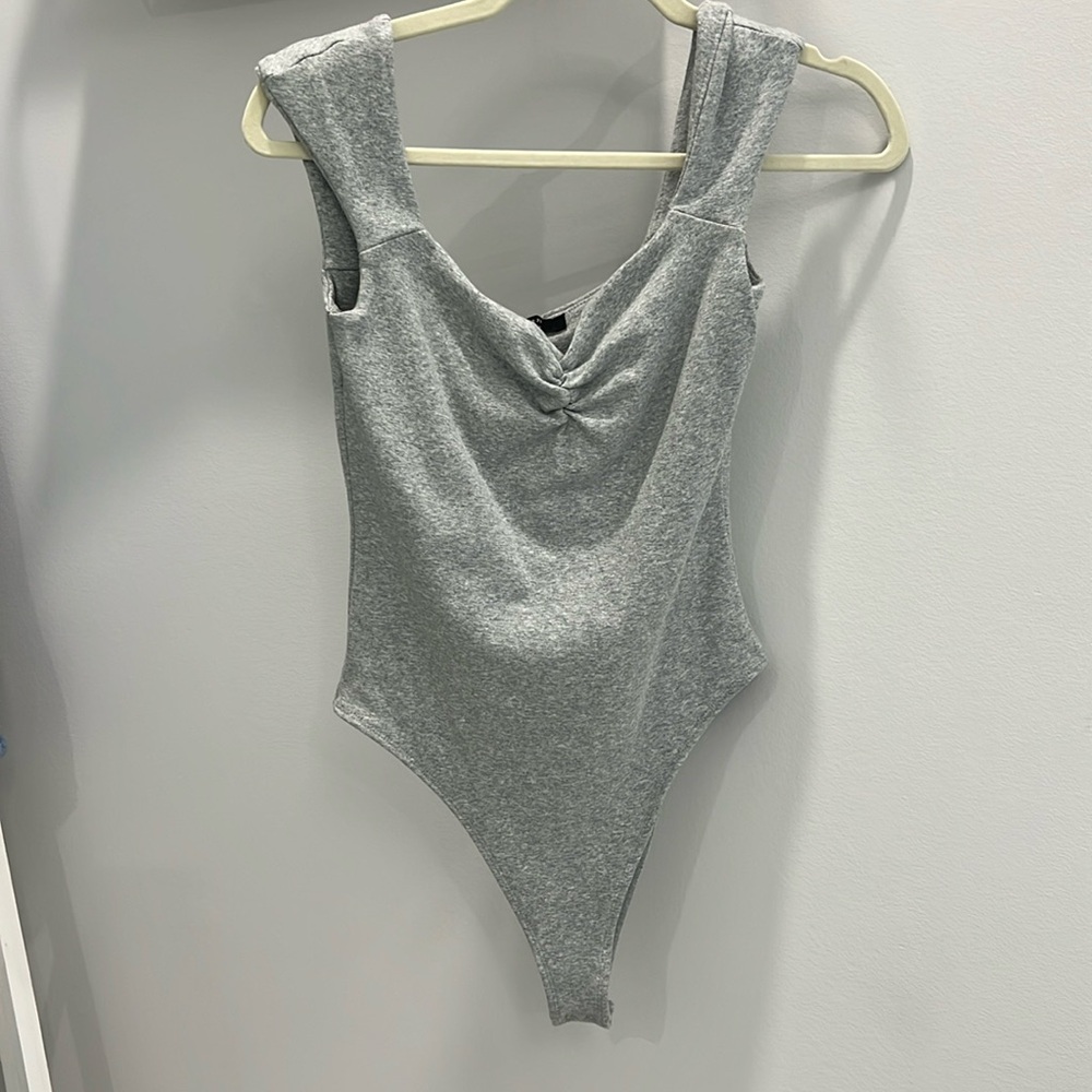 Grey bodysuit very comfortable stretchy material. Pair with any bottoms!